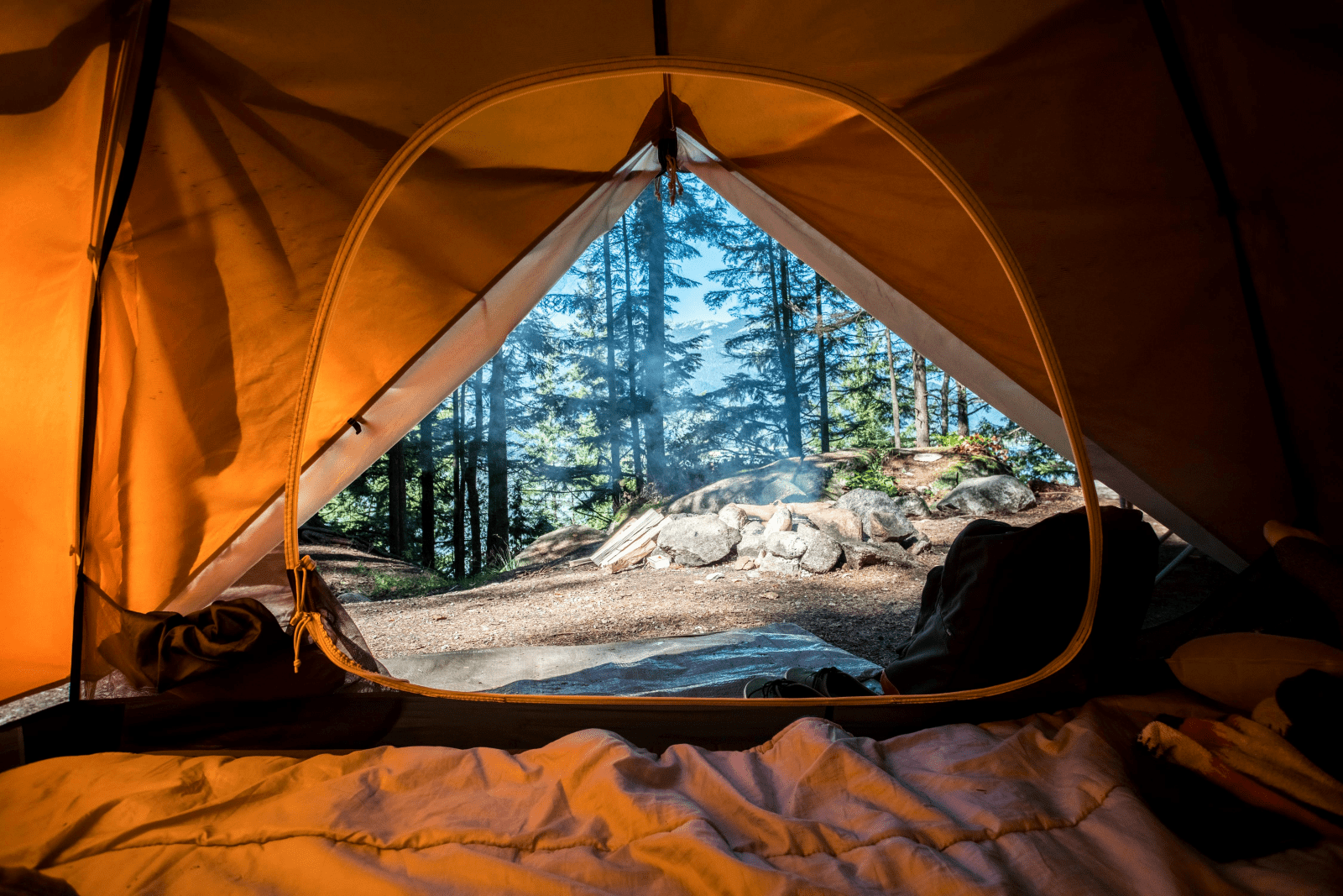 Interior view of a tent showcasing the fabric walls and the entrance, with soft light filtering through.