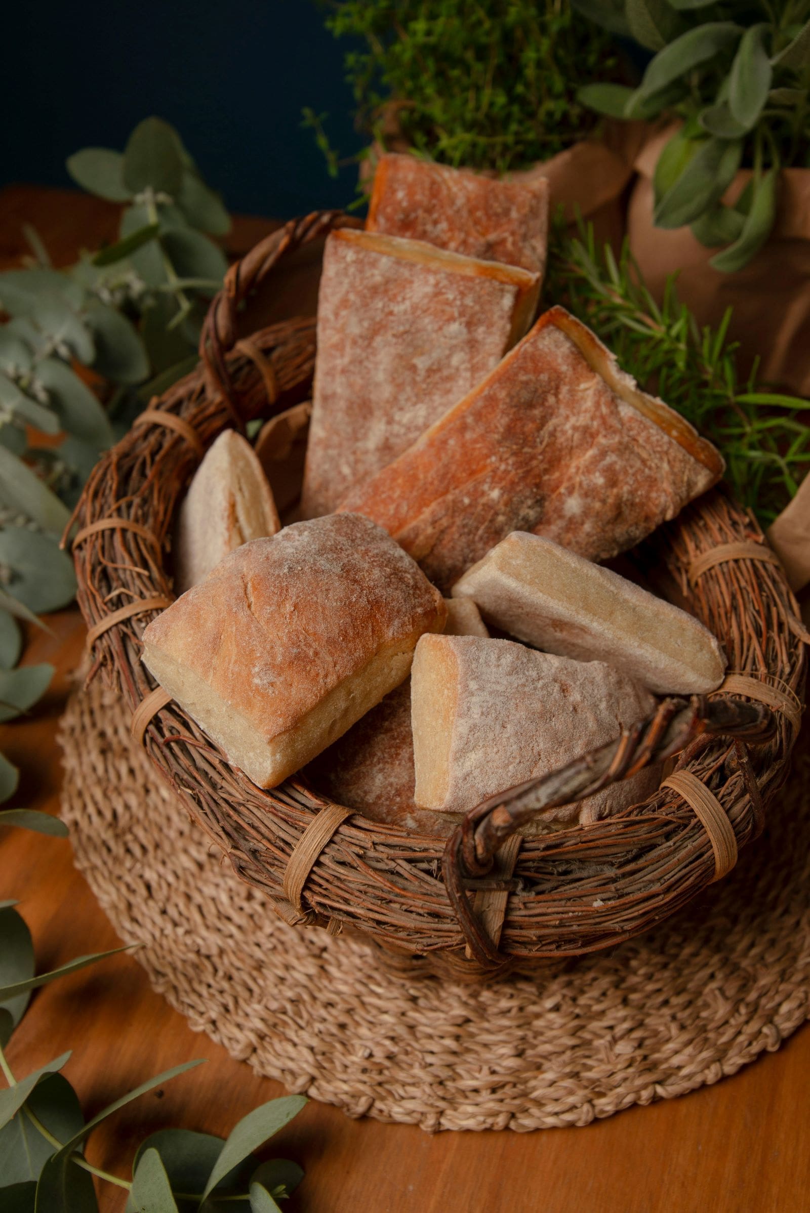 A cozy table setting featuring a basket filled with freshly baked bread, perfect for enjoying with family and friends.
