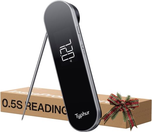 A black electronic thermometer placed next to an elegantly wrapped gift box, showcasing a thoughtful present idea.